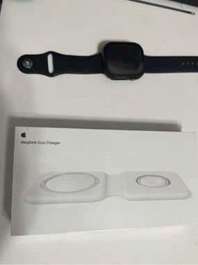 Apple MagSafe Duo Charger in white with black Apple Watch shown